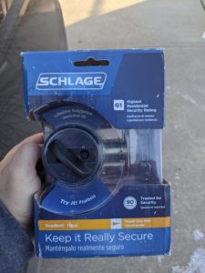 hand holding a schlage deadbolt